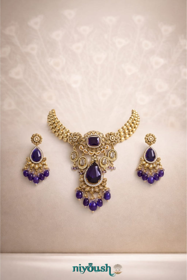 Gold necklace with purple stones and matching earrings